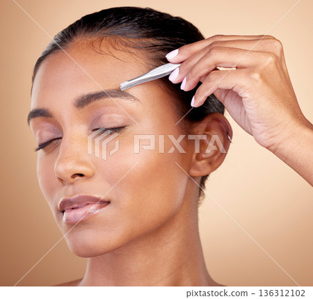 Beauty, studio or woman face with tweezers for eyebrow maintenance, hair removal or morning facial cleaning. Self care product, eyes closed or relax spa person with grooming tools on brown background 136312102