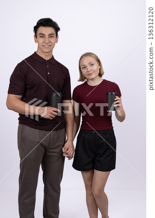 Young couple standing together in casual summer clothes Young couple standing together in casual summer clothes 136312120
