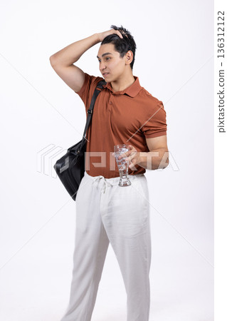 Man in orange polo shirt holding blazer over shoulder 136312122