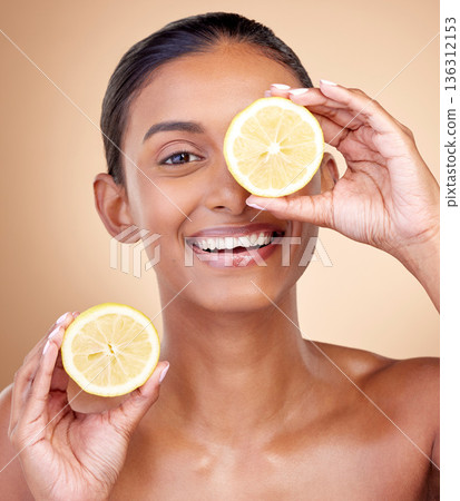 Lemon fruit, portrait and skincare of woman in studio for vitamin c benefits, eco cosmetics or nutrition. Face of indian female model, natural beauty and healthy citrus food for aesthetic dermatology Lemon fruit, portrait and skincare of woman in studio for vitamin c benefits, eco cosmetics or nutrition. Face of indian female model, natural beauty and healthy citrus food for aesthetic dermatology 136312153