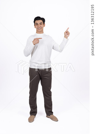 Man in white shirt pointing sideways with finger 136312195
