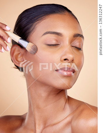 Beauty, makeup and foundation with woman and brush in studio for facial, relax and self care. Cosmetics, product and tools with face of model on brown background for glow, skincare and dermatology Beauty, makeup and foundation with woman and brush in studio for facial, relax and self care. Cosmetics, product and tools with face of model on brown background for glow, skincare and dermatology 136312247