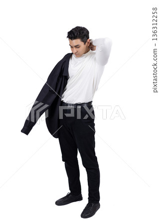 Young man in black clothes holding a blazer over shoulder Young man in black clothes holding a blazer over shoulder 136312258
