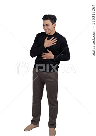 Man in black shirt standing with hand on his heart 136312264