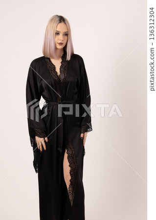 Blonde female model standing with arms down looking at camera Blonde female model standing with arms down looking at camera 136312304