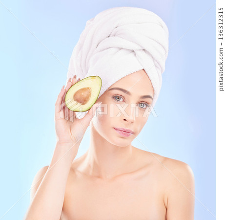 Woman, portrait and avocado, natural beauty and vitamin c with sustainable skincare isolated on blue background. Face, female model with fruit and eco friendly dermatology, cosmetic care in studio Woman, portrait and avocado, natural beauty and vitamin c with sustainable skincare isolated on blue background. Face, female model with fruit and eco friendly dermatology, cosmetic care in studio 136312315