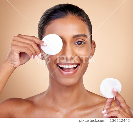 Happy woman, cotton pad and skincare for eyes, face or aesthetic cosmetics on studio background. Portrait of indian female model, beauty and facial product for makeup, toner wipe or clean dermatology Happy woman, cotton pad and skincare for eyes, face or aesthetic cosmetics on studio background. Portrait of indian female model, beauty and facial product for makeup, toner wipe or clean dermatology 136312443