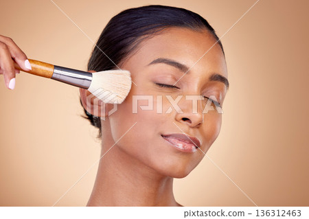 Beauty, makeup and relax with woman and brush in studio for facial, foundation and self care. Cosmetics, product and tools with face of model on brown background for glow, skincare and dermatology Beauty, makeup and relax with woman and brush in studio for facial, foundation and self care. Cosmetics, product and tools with face of model on brown background for glow, skincare and dermatology 136312463
