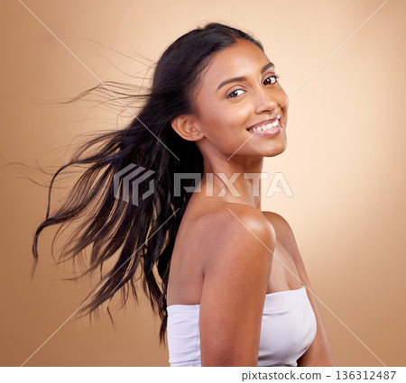Portrait, haircare and salon for indian woman with beauty in brown studio background with glow. Hairstyle, happy face and girl with shine or keratin treatment, volume and natural cosmetic in mockup. Portrait, haircare and salon for indian woman with beauty in brown studio background with glow. Hairstyle, happy face and girl with shine or keratin treatment, volume and natural cosmetic in mockup. 136312487