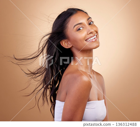 Salon, hairstyle and beauty with indian woman or shine in brown studio background. Haircare, shine and happy face with wind or growth for glow with keratin treatment in mockup or natural cosmetics. Salon, hairstyle and beauty with indian woman or shine in brown studio background. Haircare, shine and happy face with wind or growth for glow with keratin treatment in mockup or natural cosmetics. 136312488
