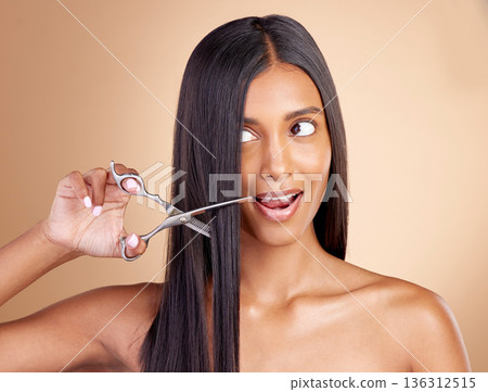Cutting, hair care or girl with scissors for beauty or self care for grooming on brown background in studio. Transformation, salon or Indian woman with tools or cosmetics gear for haircut treatment Cutting, hair care or girl with scissors for beauty or self care for grooming on brown background in studio. Transformation, salon or Indian woman with tools or cosmetics gear for haircut treatment 136312515