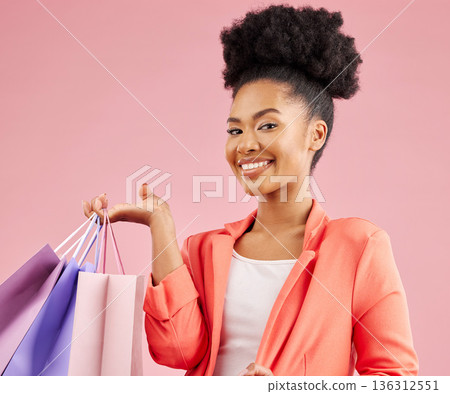 Happy African woman, shopping bag and studio portrait for discount, sale or smile by pink background. Young gen z girl, promotion and excited for deal, retail customer experience or fashion for gift Happy African woman, shopping bag and studio portrait for discount, sale or smile by pink background. Young gen z girl, promotion and excited for deal, retail customer experience or fashion for gift 136312551