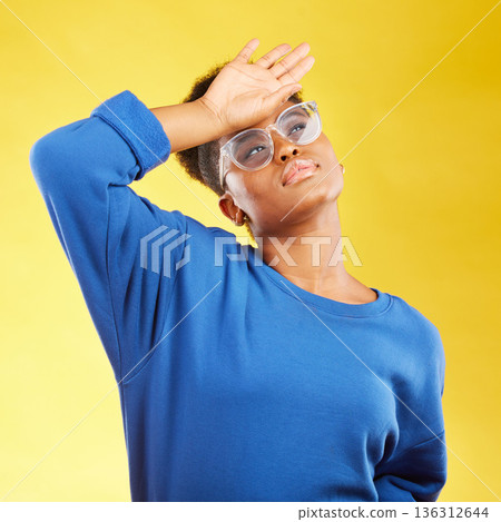 Thinking, tired and black woman with headache in studio isolated on a yellow background. Stress, problem and sick African person with financial crisis, fatigue and brain fog, vertigo and frustrated Thinking, tired and black woman with headache in studio isolated on a yellow background. Stress, problem and sick African person with financial crisis, fatigue and brain fog, vertigo and frustrated 136312644