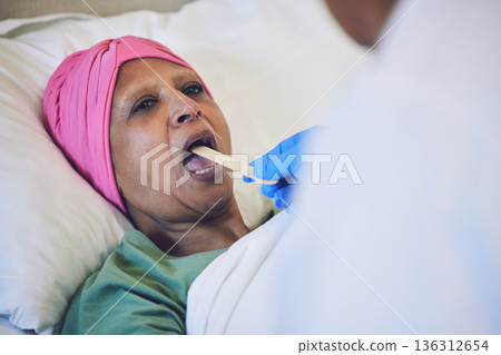 Throat stick, cancer and patient in bed with cold, flu or respiratory illness at her home. Sick, medical and woman at a doctor consultation or checkup for infection or disease in clinic or hospital. Throat stick, cancer and patient in bed with cold, flu or respiratory illness at her home. Sick, medical and woman at a doctor consultation or checkup for infection or disease in clinic or hospital. 136312654