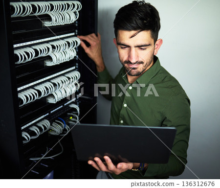 Laptop, data center and male technician in a server room for technical repairs by a control box. Technology, engineering and professional man electrician working on computer for cybersecurity system. 136312676