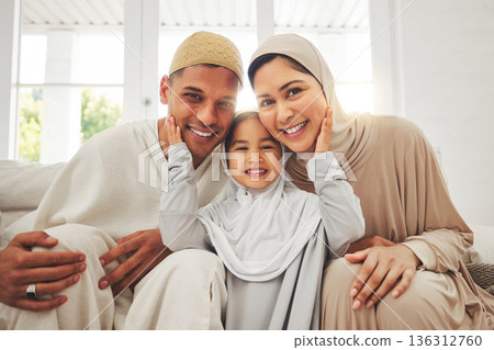 Portrait of parents, child on sofa and Islam, smile for Eid with mom, dad and daughter with home culture in Indonesia. Muslim man, woman in hijab and kid, happy family at Ramadan on sofa together. 136312760