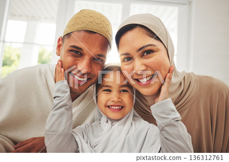 Islam, portrait and smile, parents and kid in living room for Eid with mom, dad and daughter with home culture. Face of Muslim man, woman in hijab and child in Ramadan on sofa together in Indonesia. 136312761