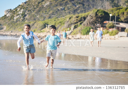 Kids, brother and sister running at beach, excited and holding hands with smile, adventure and vacation. Young children, happy and playful with race, games and freedom by ocean for summer in Hawaii Kids, brother and sister running at beach, excited and holding hands with smile, adventure and vacation. Young children, happy and playful with race, games and freedom by ocean for summer in Hawaii 136312785