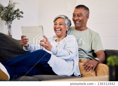 Love, tablet and senior couple laughing at funny social network meme, web comic or watch comedy podcast video. Comedy website, marriage and elderly people laugh at retirement joke in Mexico home 136312842