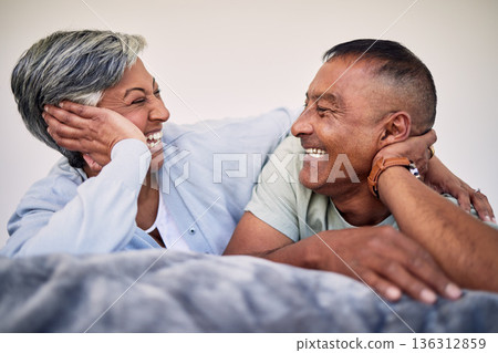 Love, bedroom face and elderly couple laugh, bond and enjoy quality time together, funny conversation and relax. Home rest, marriage care or senior woman, old man or retirement people laughing in bed Love, bedroom face and elderly couple laugh, bond and enjoy quality time together, funny conversation and relax. Home rest, marriage care or senior woman, old man or retirement people laughing in bed 136312859