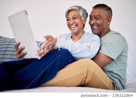 Bed, tablet and happy elderly couple laughing at funny social network blog, email or watch comedy video, podcast or meme. Funny morning article, home bedroom and senior people laugh, bond and hug Bed, tablet and happy elderly couple laughing at funny social network blog, email or watch comedy video, podcast or meme. Funny morning article, home bedroom and senior people laugh, bond and hug 136312864