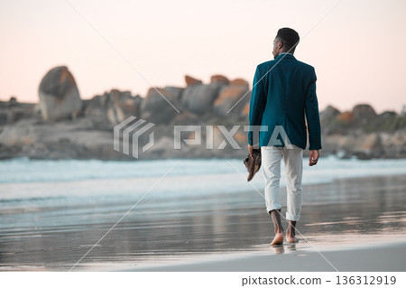 Walking, beach and back of business man for journey on holiday, vacation and freedom by ocean. Professional, travel and male entrepreneur barefoot for calm, peace and relaxing in nature at sunset Walking, beach and back of business man for journey on holiday, vacation and freedom by ocean. Professional, travel and male entrepreneur barefoot for calm, peace and relaxing in nature at sunset 136312919