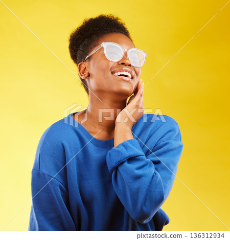 Happy, laugh and glasses with face of black woman in studio for vision, eye care and trendy style. Gen z, smile and happiness with creative female person on yellow background for pride and health Happy, laugh and glasses with face of black woman in studio for vision, eye care and trendy style. Gen z, smile and happiness with creative female person on yellow background for pride and health 136312934