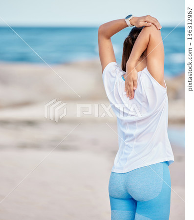 Woman, fitness and stretching body on beach in workout or getting ready for exercise or outdoor training. Back of sport female person in warm up or healthy wellness on ocean with mockup space 136312967