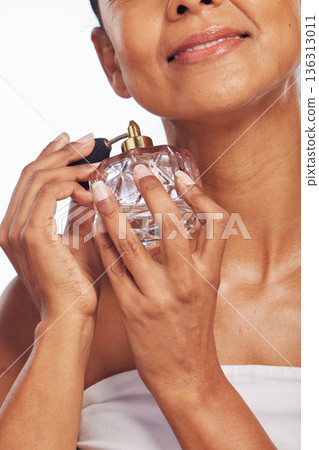 Woman, spray and hands with perfume for beauty in studio, white background or aesthetic product of fresh scent. Closeup of female model with fragrance cosmetics, parfum application and cologne bottle Woman, spray and hands with perfume for beauty in studio, white background or aesthetic product of fresh scent. Closeup of female model with fragrance cosmetics, parfum application and cologne bottle 136313011