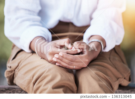 Hands anxiety, sitting and a person in nature on a bench to relax in summer for a vacation or break. Nervous, flare and a woman or girl in a park for rest, closeup or waiting in a natural environment 136313045