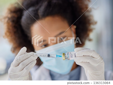 Hands, medical and a doctor or black woman with a vaccine for healthcare, virus safety or prescription. Closeup, medicine and an African nurse or hospital employee with a vial or syringe for smallpox Hands, medical and a doctor or black woman with a vaccine for healthcare, virus safety or prescription. Closeup, medicine and an African nurse or hospital employee with a vial or syringe for smallpox 136313064