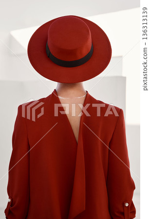 Vintage, fashion and person with red hat and white background in studio for creative, designer and retro clothing. Mystery, couture model and person in a suit with beauty, aesthetic or character Vintage, fashion and person with red hat and white background in studio for creative, designer and retro clothing. Mystery, couture model and person in a suit with beauty, aesthetic or character 136313139