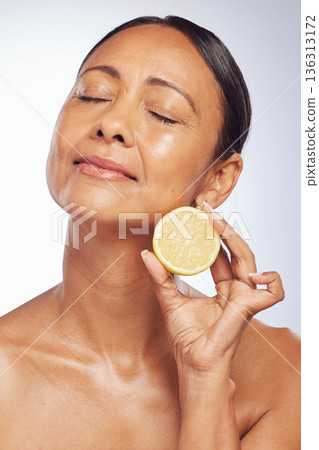 Cosmetics, orange and senior woman with skincare, dermatology and vitamin c against a white studio background. Mature female person, self care and model with citrus fruit, natural beauty and health Cosmetics, orange and senior woman with skincare, dermatology and vitamin c against a white studio background. Mature female person, self care and model with citrus fruit, natural beauty and health 136313172