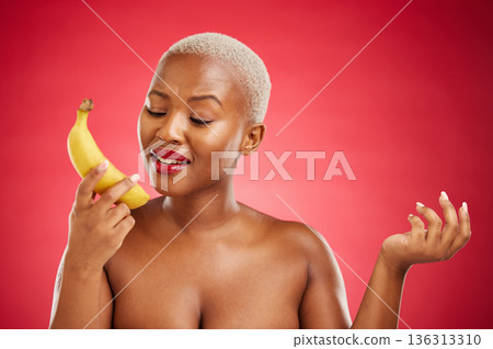 Phone call, beauty and woman acting with a banana pretending, talking and fake conversation on red background. Playful mobile communication, skincare and girl in studio with funny or crazy fruit chat Phone call, beauty and woman acting with a banana pretending, talking and fake conversation on red background. Playful mobile communication, skincare and girl in studio with funny or crazy fruit chat 136313310