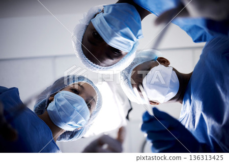 Surgery, low angle or doctors with face mask, scissors or surgical procedure or healthcare in hospital clinic. Teamwork, medical safety tools or surgeons working in gloves helping in operating room 136313425