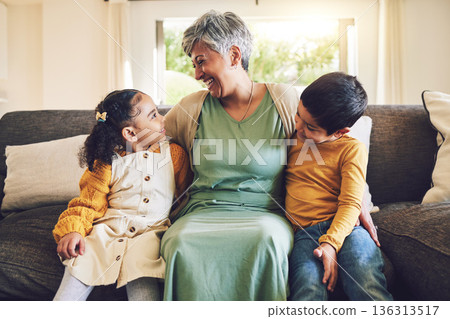 Laughing, grandmother or happy kids on a sofa with love enjoying quality bonding time together in family home. Smile, affection or funny senior grandparent hugging children siblings on house couch 136313517