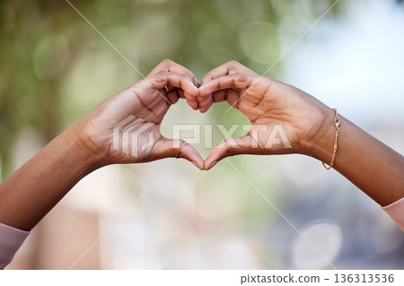 Woman, heart hands and love in nature for compassion, romance or care against a blurred background. Closeup of female person with loving symbol, gesture or sign for valentines day in the outdoors Woman, heart hands and love in nature for compassion, romance or care against a blurred background. Closeup of female person with loving symbol, gesture or sign for valentines day in the outdoors 136313536
