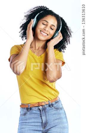 Music, happy and a woman with headphones in studio streaming audio, sound or radio. Peace, smile and a young African person isolated on a white background listening to fun song to relax or meditate Music, happy and a woman with headphones in studio streaming audio, sound or radio. Peace, smile and a young African person isolated on a white background listening to fun song to relax or meditate 136313610