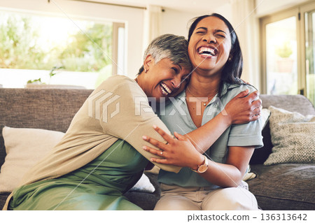 Senior mother, funny and hug woman in living room, bonding and laughing together. Happy, elderly mom and embrace person, relax and smile with care, love and enjoying time on home sofa with family. 136313642