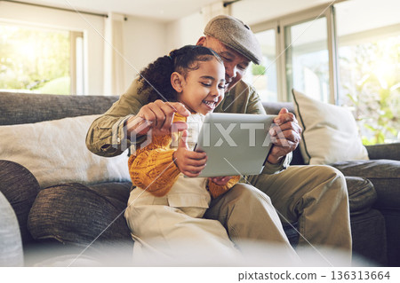 Young girl, grandfather and tablet, games and entertainment, watch cartoon or e learning while at home. Bonding, love and spending quality time, old man and female child with gadget and internet Young girl, grandfather and tablet, games and entertainment, watch cartoon or e learning while at home. Bonding, love and spending quality time, old man and female child with gadget and internet 136313664