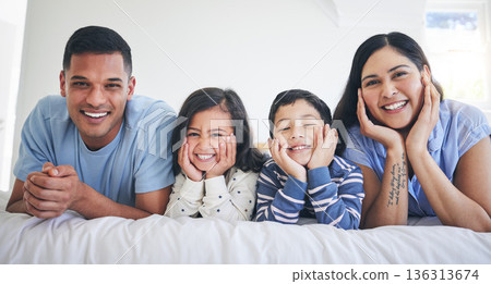 Happy family, portrait and kids with parents on a bed relax, excited and bonding in their home. Face, smile and children with mother and father in bedroom for weekend, chilling and waking up playful Happy family, portrait and kids with parents on a bed relax, excited and bonding in their home. Face, smile and children with mother and father in bedroom for weekend, chilling and waking up playful 136313674