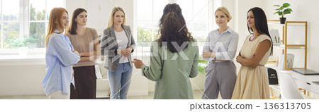 Female coach leading team workshop, women gathered for mentoring in bright office Female coach leading team workshop, women gathered for mentoring in bright office 136313705