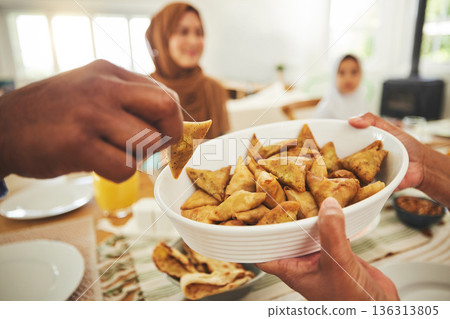 Food, samosa and muslim with hands of people at table for eid mubarak, Islamic celebration and lunch. Ramadan festival, culture and iftar with closeup of family at home for fasting, islam or religion Food, samosa and muslim with hands of people at table for eid mubarak, Islamic celebration and lunch. Ramadan festival, culture and iftar with closeup of family at home for fasting, islam or religion 136313805