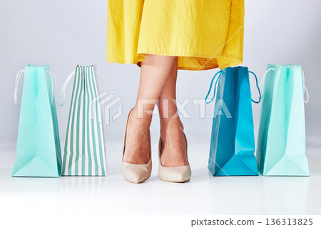 Shoes, shopping bag and a woman in studio for fashion sale, promotion or retail discount, Legs of a female model or customer on a white background for advertising commerce offer, paper bags or gift Shoes, shopping bag and a woman in studio for fashion sale, promotion or retail discount, Legs of a female model or customer on a white background for advertising commerce offer, paper bags or gift 136313825