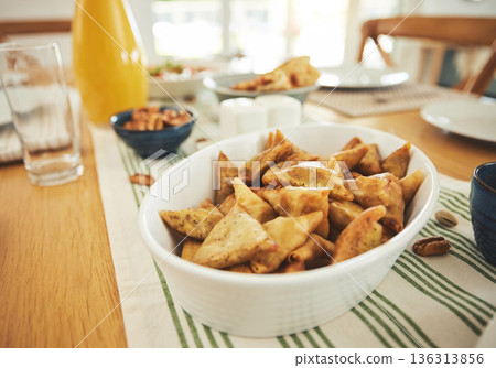 Food, Eid Mubarak and samosa for family at table for Islamic celebration, festival and lunch together. Ramadan, religion and closeup of meal, dish and cuisine for fasting end, holiday and culture 136313856