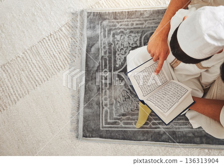 Quran, Islam child and parent on floor reading for religion learning, muslim pray and faith in Allah, god or holy spirit. Knowledge, home top view and father teaching kid worship, praying and respect 136313904