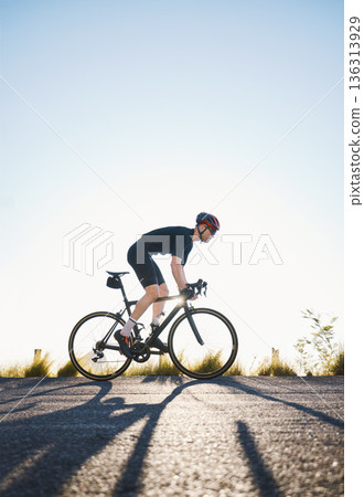 Mountain, fitness and man athlete on bicycle cycling training for a race or marathon in nature. Sports, workout and male cyclist riding a bike for cardio exercise on an outdoor off road trail. Mountain, fitness and man athlete on bicycle cycling training for a race or marathon in nature. Sports, workout and male cyclist riding a bike for cardio exercise on an outdoor off road trail. 136313929
