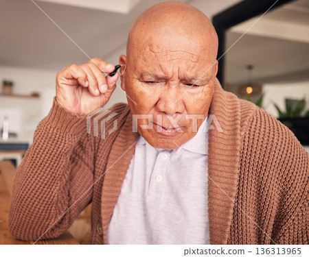 Senior man, hand and hearing aid for ears, health and wellness for retirement in nursing home. Elderly person with disability, audio or sound technology to listen, medical help or innovation at house 136313965