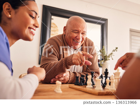 Senior man, nursing home and chess for game, competition and happy with friends, strategy and relax together. Elderly person, nurse and board for contest with mindset, excited smile or point at table 136313966