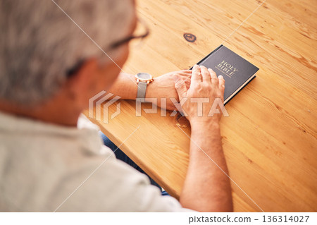 Bible, hands or above of old man in prayer for support, faith or hope in Christianity in retirement. Worship, praying or senior person studying, reading or learning book of God in spiritual religion Bible, hands or above of old man in prayer for support, faith or hope in Christianity in retirement. Worship, praying or senior person studying, reading or learning book of God in spiritual religion 136314027
